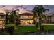 Exterior view of two story home with screened in patio, lush landscaping, and a beautiful yard at 8161 Via Rosa, Orlando, FL 32836
