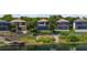 A view of the back exterior showcasing a multi-story home with a dock on the lake at 8161 Via Rosa, Orlando, FL 32836