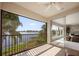 This beautiful balcony features a ceiling fan and a stunning view of the water beyond its black railing at 8161 Via Rosa, Orlando, FL 32836