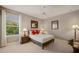 Cozy bedroom with neutral walls, carpet, a ceiling fan, and window offering beautiful views at 8161 Via Rosa, Orlando, FL 32836