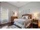 This beautiful bedroom features a neutral color palette, hardwood floors, and lots of natural light at 8161 Via Rosa, Orlando, FL 32836