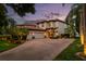 Stunning home featuring a brick driveway, lush landscaping, and a tile roof at 8161 Via Rosa, Orlando, FL 32836