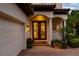 Inviting front entrance with double doors, brick pavers, and a well-lit porch next to a garage at 8161 Via Rosa, Orlando, FL 32836