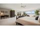 Large main bedroom suite with a sitting area, access to a private balcony and water views at 8161 Via Rosa, Orlando, FL 32836