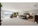 Spacious main bedroom suite with sitting area, large windows showcasing water views, and a ceiling fan at 8161 Via Rosa, Orlando, FL 32836