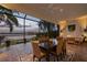Screened-in dining patio provides the perfect space to enjoy an evening dinner with lake views at 8161 Via Rosa, Orlando, FL 32836