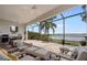 Screened-in patio features comfortable seating and dining area, perfect for enjoying the lake view at 8161 Via Rosa, Orlando, FL 32836