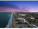 Night aerial view shows condo buildings along the beach with ocean views and city access at 901 S Atlantic Ave # 3, Ormond Beach, FL 32176