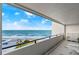 Balcony view overlooking the ocean with blue skies and a building nearby at 901 S Atlantic Ave # 3, Ormond Beach, FL 32176