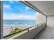 Beautiful balcony view of the ocean with clear blue skies and a glimpse of the beach at 901 S Atlantic Ave # 3, Ormond Beach, FL 32176