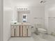 Bright bathroom with a cream vanity, large mirror, and white tiled floors at 901 S Atlantic Ave # 3, Ormond Beach, FL 32176