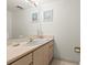 Bathroom vanity area with a mirror, pink countertop, and storage cabinets, providing a functional space at 901 S Atlantic Ave # 3, Ormond Beach, FL 32176