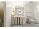 Bathroom with a neutral color scheme, featuring a toilet, sink, and mirror at 901 S Atlantic Ave # 3, Ormond Beach, FL 32176