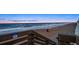 Stairs leading down to the beach with soft sand and ocean views at 901 S Atlantic Ave # 3, Ormond Beach, FL 32176