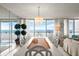 Bright dining area with a large table, chandelier, and ocean views at 901 S Atlantic Ave # 3, Ormond Beach, FL 32176