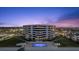 Aerial view of a condo building featuring a pool, well-maintained lawn, and easy beach access at 901 S Atlantic Ave # 3, Ormond Beach, FL 32176