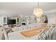 Spacious living area with open layout, featuring an elegant dining table and a partial view of the kitchen at 901 S Atlantic Ave # 3, Ormond Beach, FL 32176