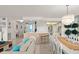 Spacious living area with open layout, featuring an elegant dining table and a partial view of the kitchen at 901 S Atlantic Ave # 3, Ormond Beach, FL 32176