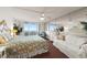 Bright main bedroom with ceiling fan, water view balcony, and mirrored wall at 901 S Atlantic Ave # 3, Ormond Beach, FL 32176