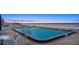 Community swimming pool and lounge area near the beach at dusk at 901 S Atlantic Ave # 3, Ormond Beach, FL 32176