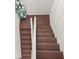 Carpeted stairway with white railing and trim leading to the upper level at 901 S Atlantic Ave # 3, Ormond Beach, FL 32176