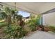The backyard features tropical plants, a covered patio, and a concrete path at 908 Hillary Ct # 15, Orlando, FL 32804