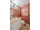 Charming powder room with patterned wallpaper, a white vanity, and artistic decor, adding character to the space at 908 Hillary Ct # 15, Orlando, FL 32804
