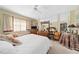 This charming bedroom features a ceiling fan, mirror and a comfortable bed with decorative pillows at 908 Hillary Ct # 15, Orlando, FL 32804