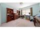 This bedroom features bright blue walls, built-in bookshelves, and a window with natural light at 908 Hillary Ct # 15, Orlando, FL 32804