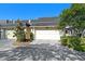 Attached two-car garage of home in a residential neighborhood featuring manicured landscaping and paved driveway at 908 Hillary Ct # 15, Orlando, FL 32804