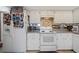 Functional kitchen featuring white appliances and cabinetry, providing a clean and efficient cooking space at 908 Hillary Ct # 15, Orlando, FL 32804