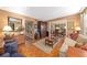 Cozy living room with parquet floors, dark wood furniture, and an open view to the dining room beyond at 908 Hillary Ct # 15, Orlando, FL 32804