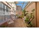 Enclosed brick patio with seating, potted plants, and a skylight offering natural light, creating a serene outdoor space at 908 Hillary Ct # 15, Orlando, FL 32804