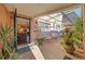 Enclosed brick patio with seating, potted plants, and skylight, as seen from the home's open entryway at 908 Hillary Ct # 15, Orlando, FL 32804