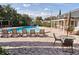 This community pool features lounge chairs and tables for residents to relax and enjoy at 908 Hillary Ct # 15, Orlando, FL 32804