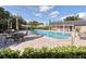 Community pool features lounge chairs and tables for relaxation and recreation at 908 Hillary Ct # 15, Orlando, FL 32804