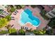 Aerial view of a uniquely shaped community pool surrounded by lounge chairs and tropical landscaping at 911 N Orange Ave # 541, Orlando, FL 32801