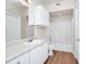 Bright bathroom with white cabinets, vanity, updated lighting and a shower-tub combo at 911 N Orange Ave # 541, Orlando, FL 32801