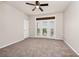 An open bedroom features a ceiling fan and a double door opening onto a small patio at 911 N Orange Ave # 541, Orlando, FL 32801
