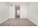 A carpeted bedroom features neutral paint and a hallway leading to the bathroom at 911 N Orange Ave # 541, Orlando, FL 32801