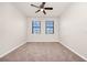 A spacious bedroom shows two windows for natural light, carpet, and neutral paint at 911 N Orange Ave # 541, Orlando, FL 32801