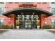 Inviting entrance to Uptown Place features glass doors, planters, and overhead lighting at 911 N Orange Ave # 541, Orlando, FL 32801