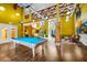 Spacious game room with a pool table, lounge area, and high ceilings, perfect for entertaining guests at 911 N Orange Ave # 541, Orlando, FL 32801