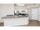 Bright kitchen featuring white cabinets, stainless steel appliances, and a breakfast bar at 911 N Orange Ave # 541, Orlando, FL 32801