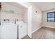 Bright laundry room with updated appliances, overhead shelving, and a window for natural light at 911 N Orange Ave # 541, Orlando, FL 32801