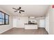 Open concept living room features hardwood floors, plenty of natural light, and leads to the kitchen at 911 N Orange Ave # 541, Orlando, FL 32801