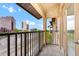 Covered patio with black metal railing and an open view of nearby buildings and train tracks at 911 N Orange Ave # 541, Orlando, FL 32801