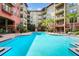 Resort-style pool surrounded by lush landscaping and multi-story apartment complex at 911 N Orange Ave # 541, Orlando, FL 32801