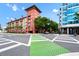 A vibrant street corner shows the property's colorful facade and crosswalks under a bright blue sky at 911 N Orange Ave # 541, Orlando, FL 32801