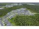 An expansive aerial shot captures the residential area nestled amidst the lush greenery and tranquil lake at 9763 Brown Burrow St, Orlando, FL 32829